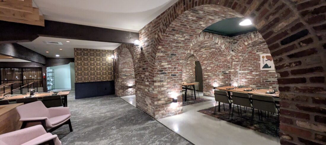 Brick arches setting off intimate areas in the dining room of Sweet Waters on the River at Valley River Inn in Eugene, Oregon. 