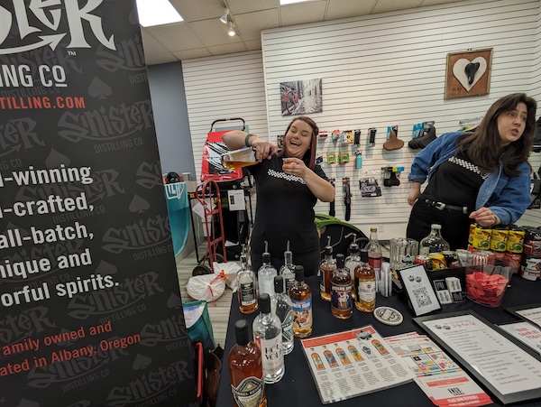 Sinister Distillery and Deluxe Brewing pouring samples at the 2024 Sip, Savor, Stroll event in Eugene.